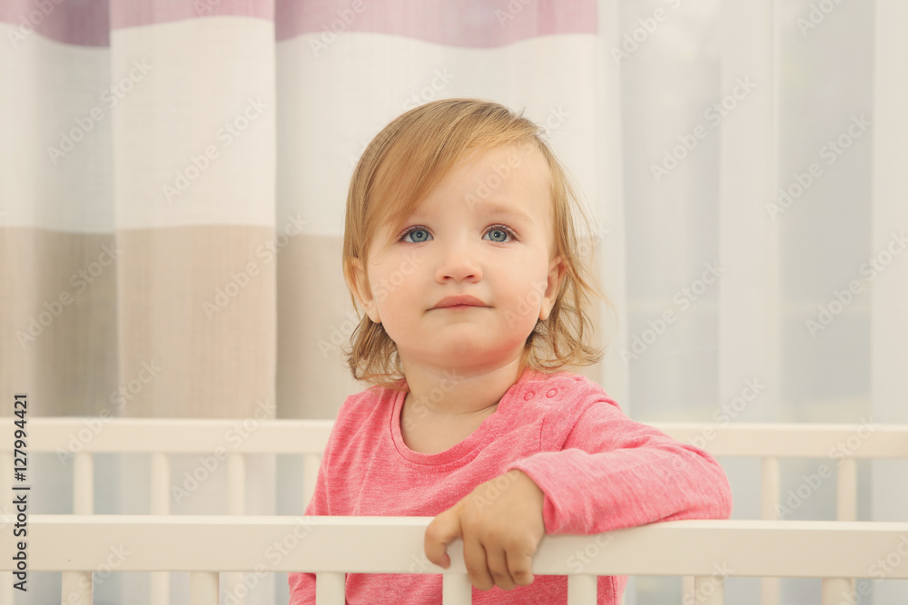 Cute little girl in cradle at baby room Cute little girl in cradle at baby room