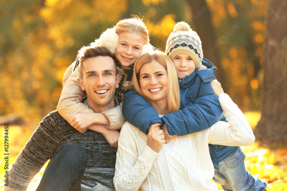 Happy family resting in beautiful autumn park