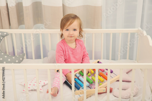 Cute little girl with toys ...