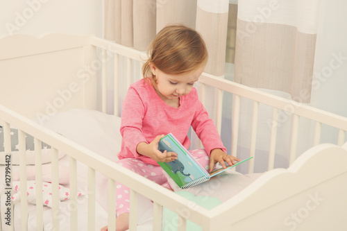 Cute little girl with book ...
