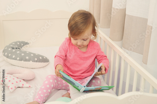 Cute little girl with book ...