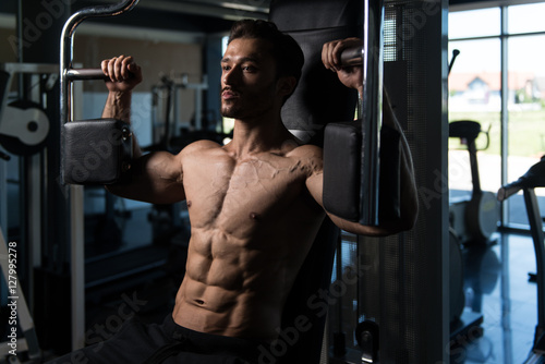 Man Doing Butterfly Chest Exercise On Machine