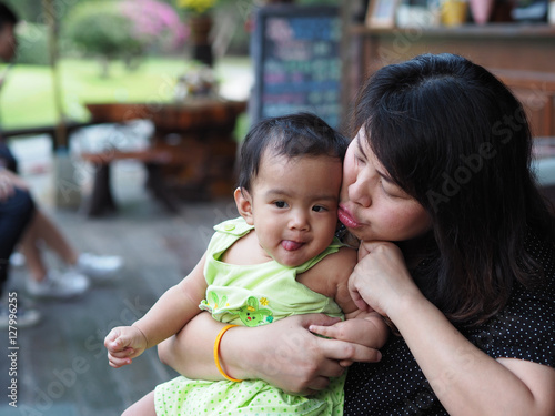 Asia Baby Girl playing with mom in the public park.