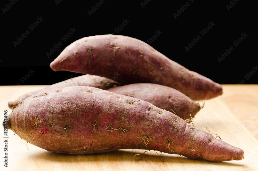 Purple sweet potatoes on wooden,healthy food Purple sweet potatoes on wooden,healthy food
