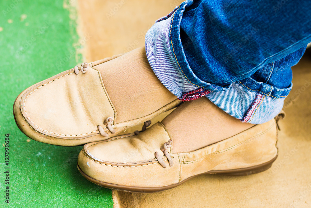 Close up of stylish female shoes. Outdoor fashion shoes footwear concept,Woman's legs in blue jeans. Close up of stylish female shoes. Outdoor fashion shoes footwear concept,Woman's legs in blue jeans.