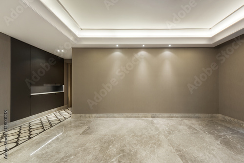 Empty room with marble flooring and wall paper decoration