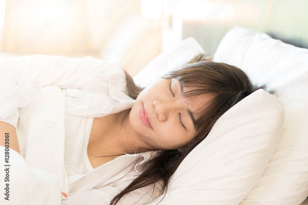 Women sleeping on bed with soft light. Women sleeping on bed with soft light.