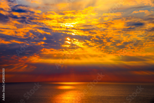 Sunset over sea with reflection