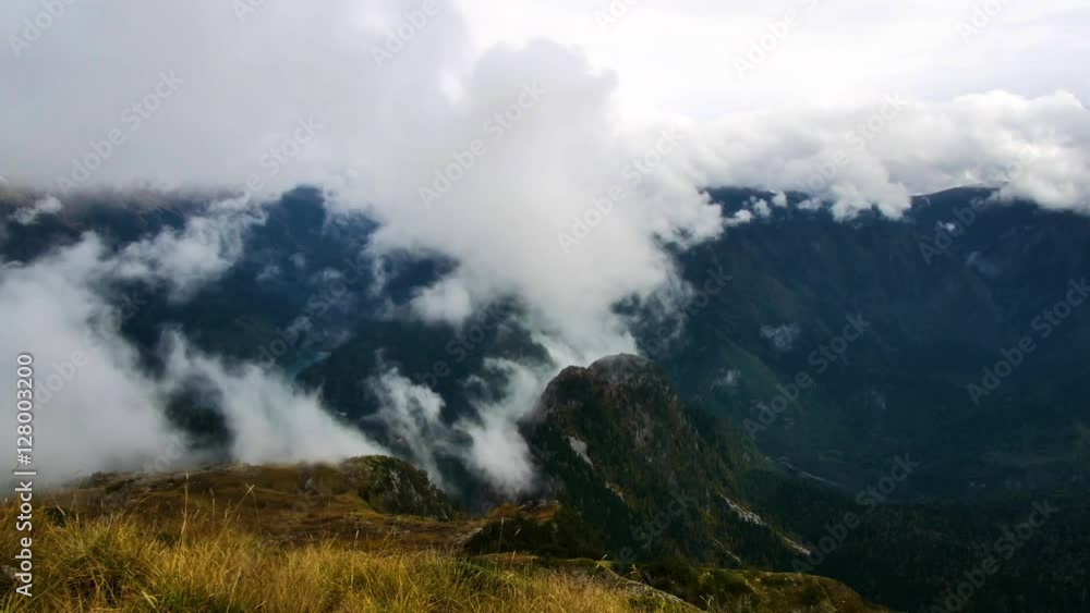 Clouds rising up the mountains, colorful autumn landscape Clouds rising up the mountains, colorful autumn landscape