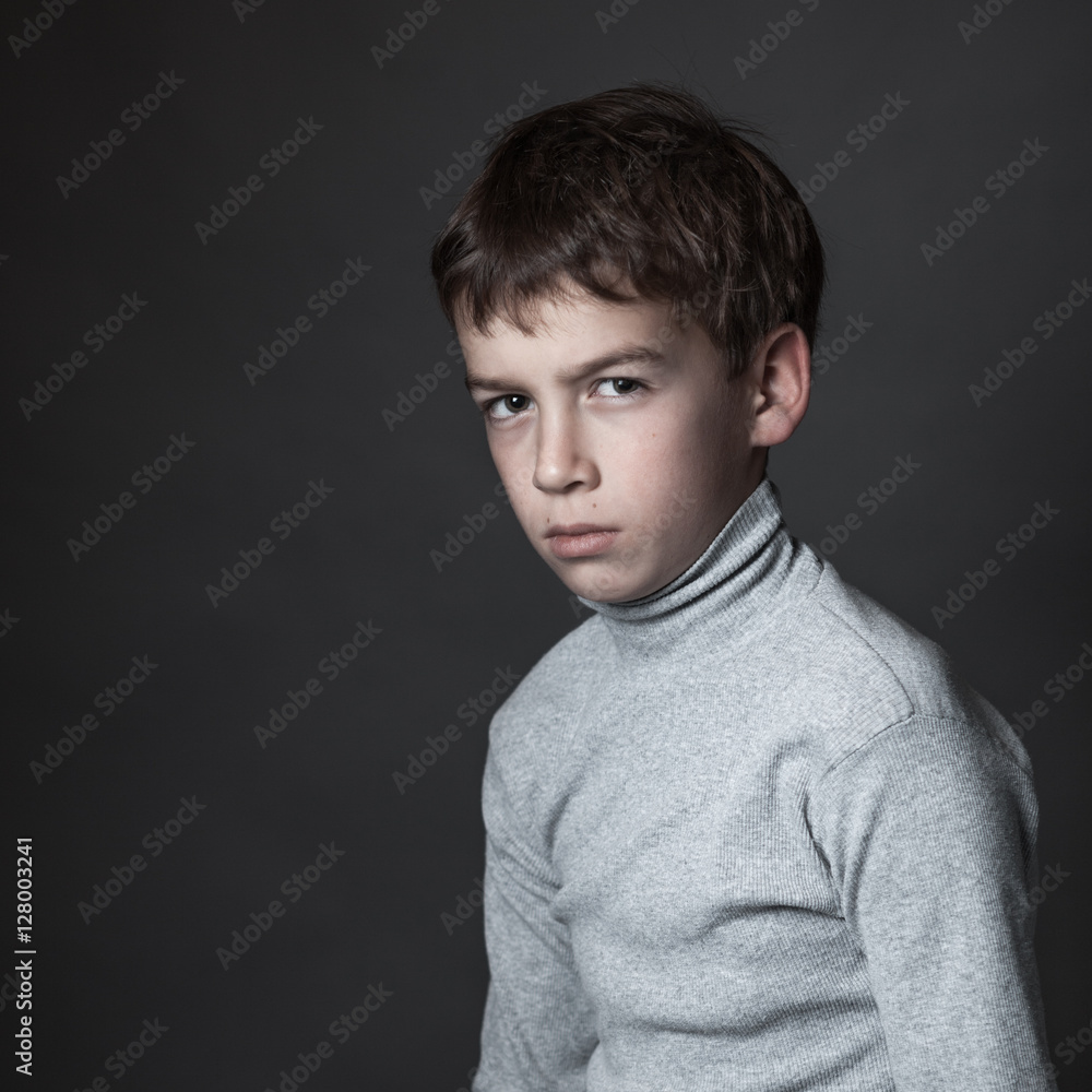 Fototapeta premium Portrait of sad teenager on gray background,