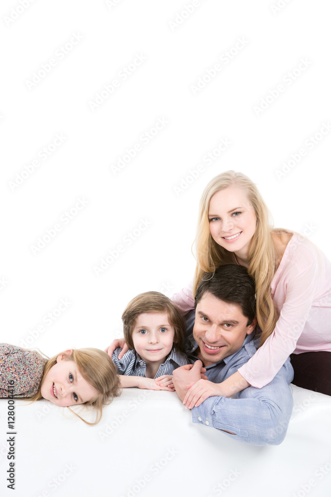Family of four on a sofa at home