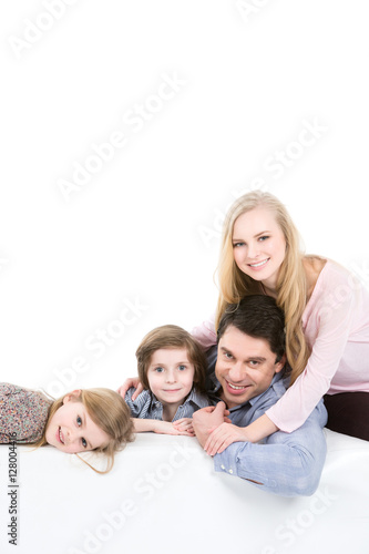 Family of four on a sofa at home
