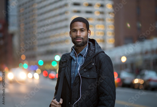 Portrait of African American man listening to music in the city