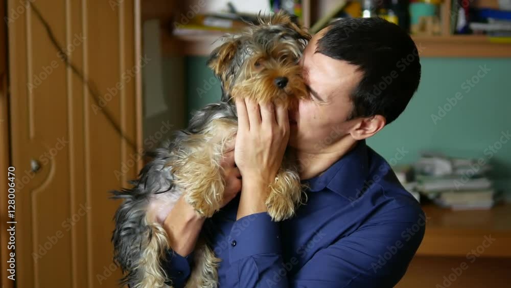man embraces pet and kisses a dog indoor friendship man embraces pet and kisses a dog indoor friendship