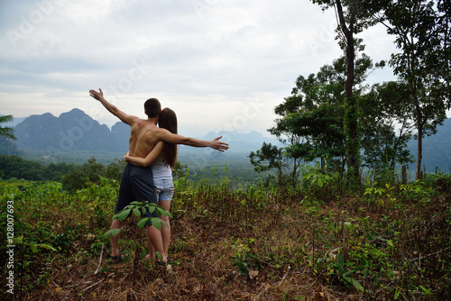 Young man and woman hiking in tropical jungle of Thailand
