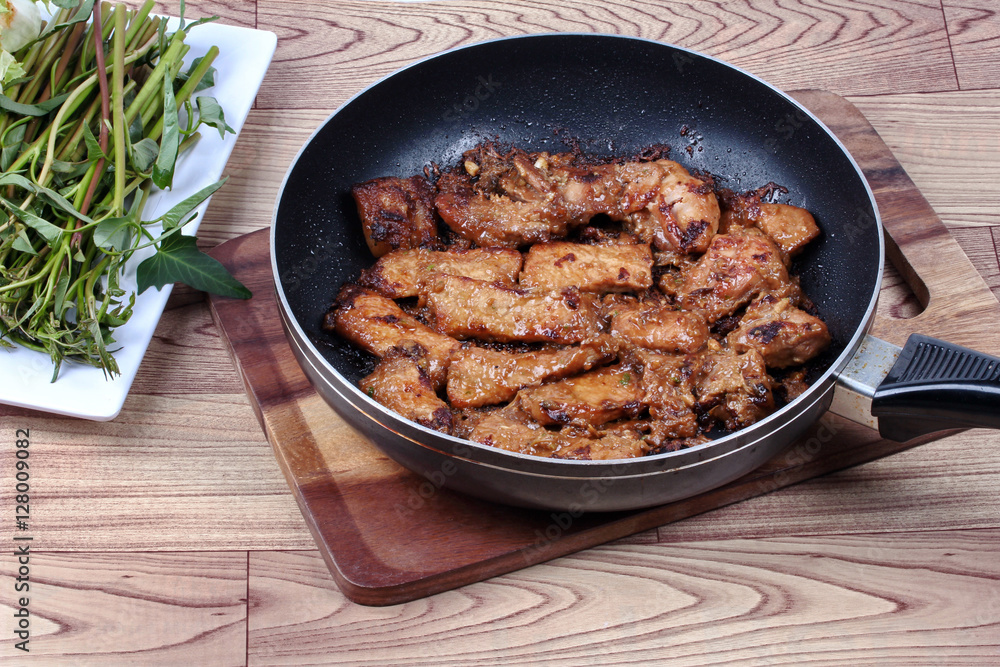 Ready grilled pork with mixed herb in pan served. Ready grilled pork with mixed herb in pan served.