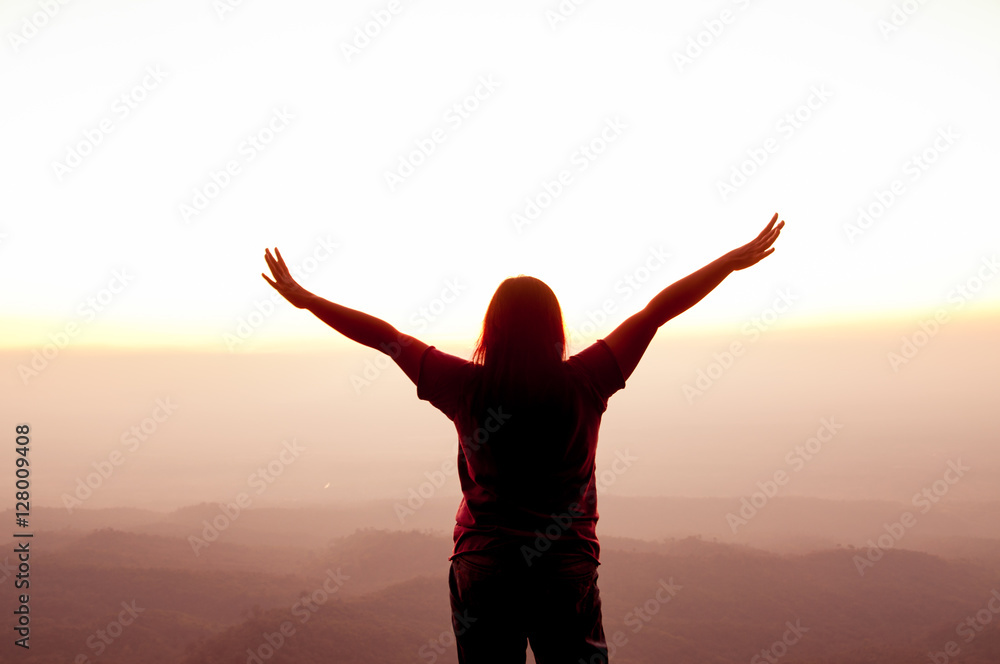 Woman opens arm with sunset sky background, inspiration and freedom concept Woman opens arm with sunset sky background, inspiration and freedom concept