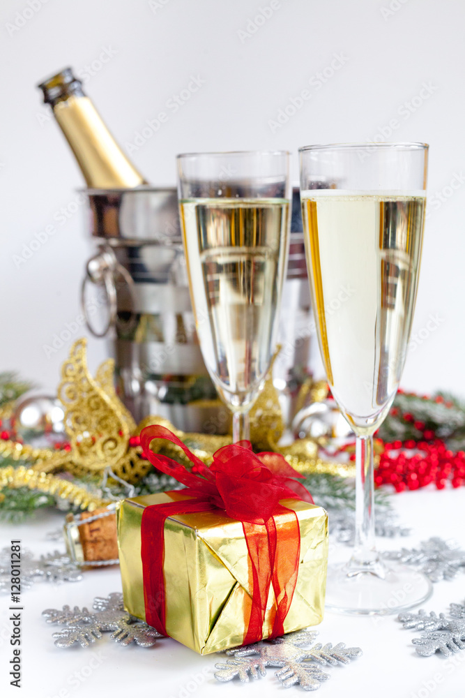 glasses of champagne and Christmas ornaments on white background glasses of champagne and Christmas ornaments on white background