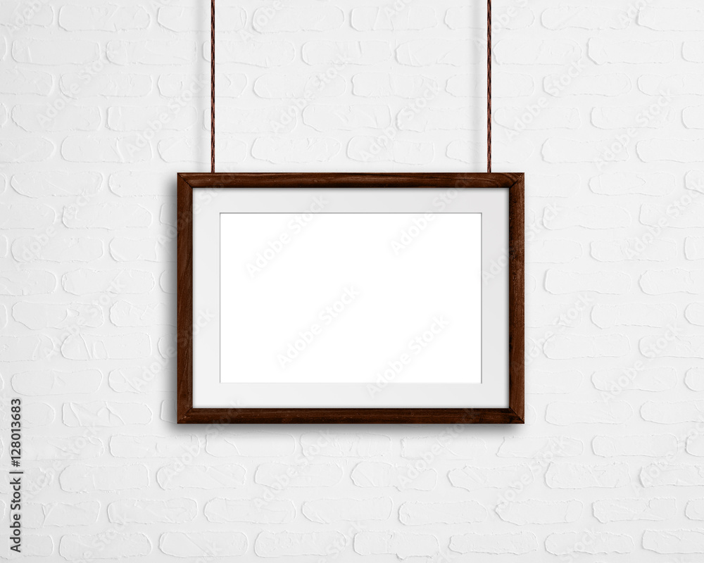 Brown natural wooden frame, hanging on bricks wall, interiors decor mock up Brown natural wooden frame, hanging on bricks wall, interiors decor mock up