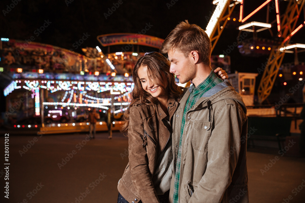 Smiling couple in amusement park Smiling couple in amusement park