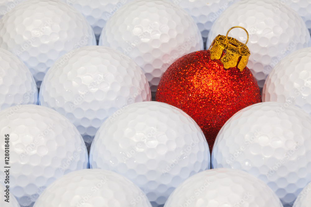 Red Christmas decoration between the golf balls Red Christmas decoration between the golf balls