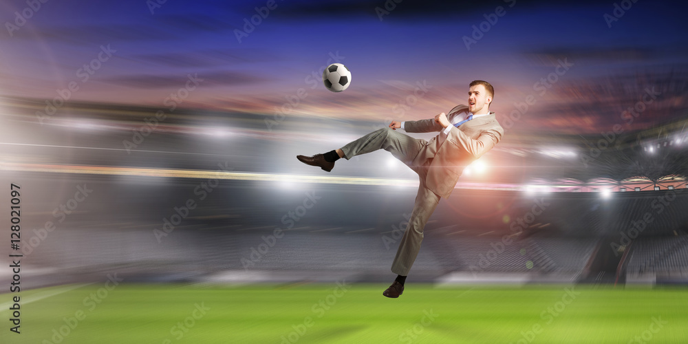 Businessman playing soccer . Mixed media