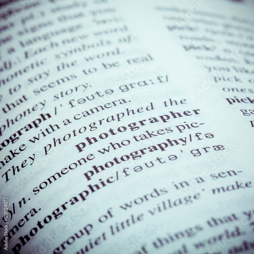 Close up of old English dictionary page with word Photographer.