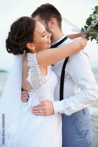 Groom and bride on river ba...