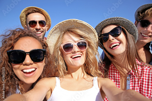 Happy friends taking selfie on beach © Africa Studio
