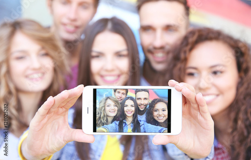 Happy friends taking selfie...