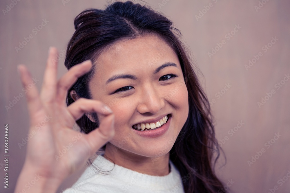 Smiling woman making ok sign with hand Smiling woman making ok sign with hand