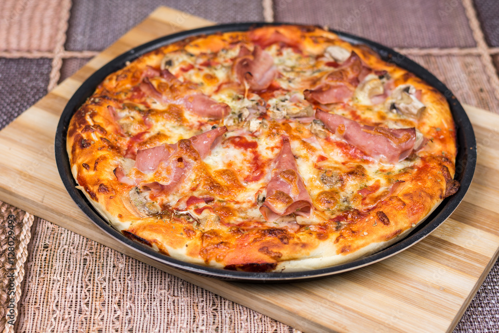 Delicious pizza with ham cheese mushrooms Delicious pizza with ham cheese mushrooms
