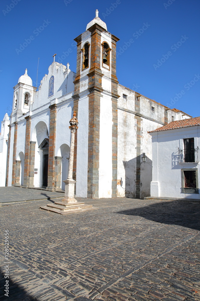MONSARAZ, PORTUGAL: Santa Maria da Lagoa Church with a pillory in the foreground 