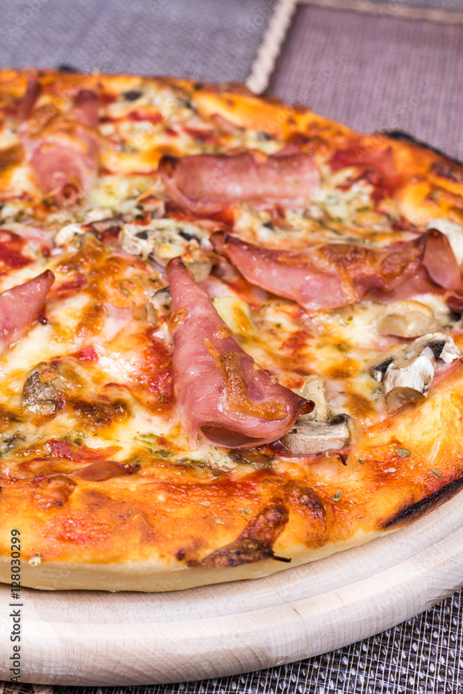 Closeup macro view pizza with ham cheese mushrooms