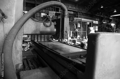 Industrial surface grinding machine. Black-and-white photo.