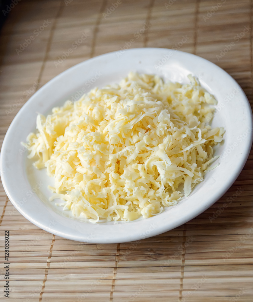 grated cheese on a white plate