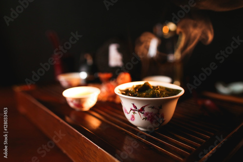 Traditional Chinese tea ceremony. Porcelain gaiwan with tea. Soft selective focus. photo