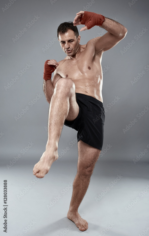 Muay thai fighter on gray background Muay thai fighter on gray background