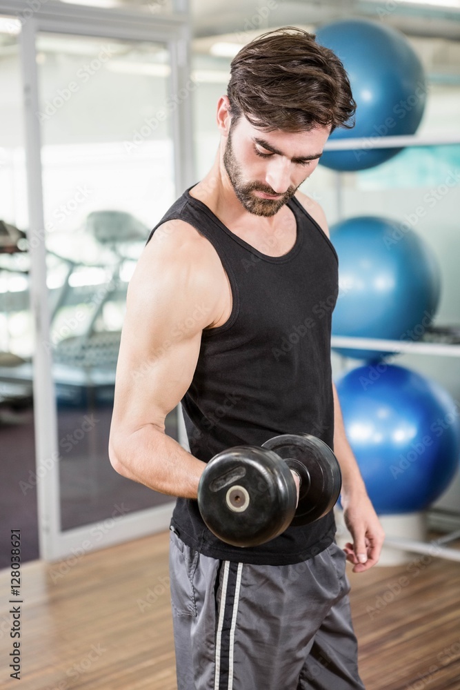 Concentrated man lifting dumbbells Concentrated man lifting dumbbells