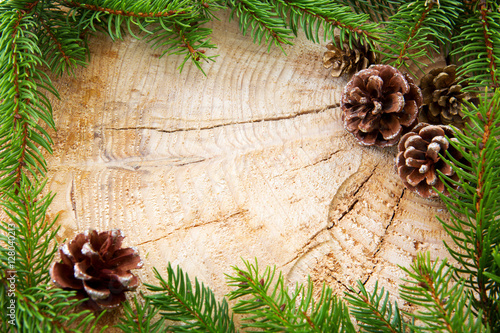 Tableau sur toile Christmas frame decorated with fir cones and green branches.