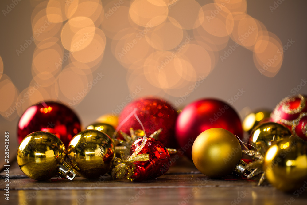 Shiny Christmas balls laying on a rustic table, ready to be hung Shiny Christmas balls laying on a rustic table, ready to be hung