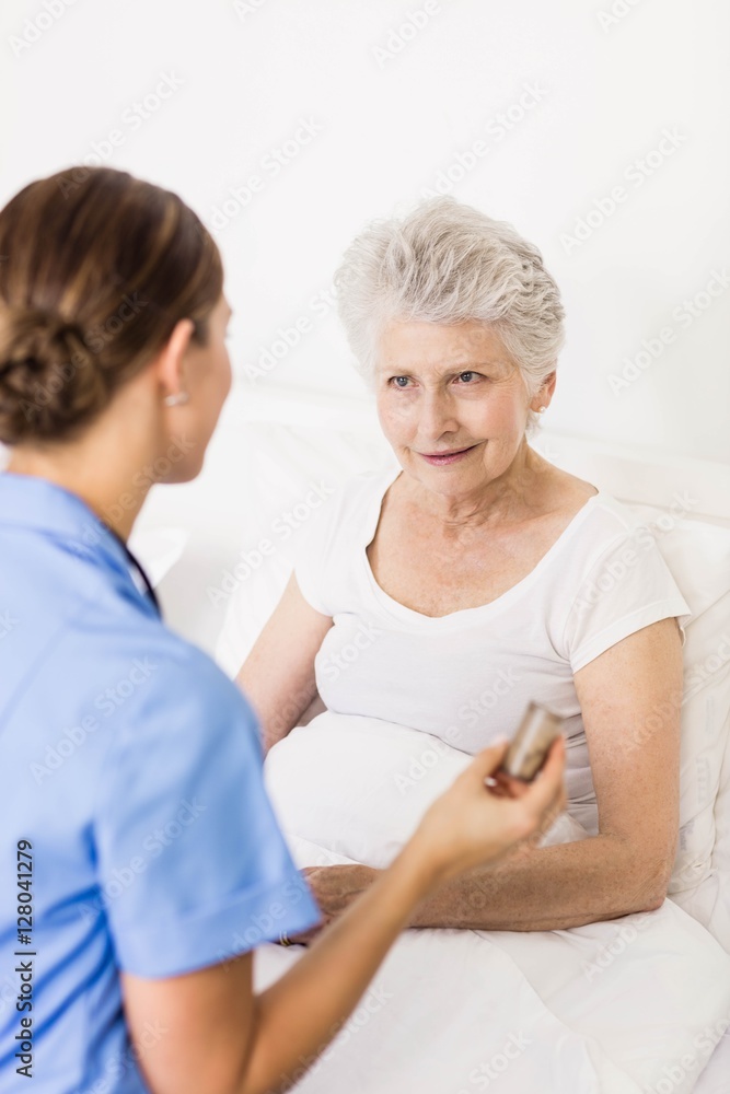 Nurse taking care of suffering senior patient Nurse taking care of suffering senior patient