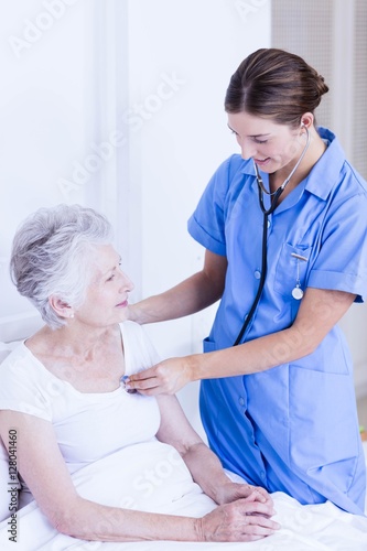 Doctor taking care of suffering senior patient 