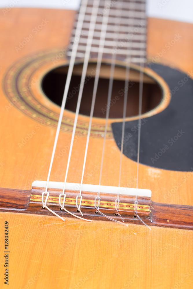 Acoustic guitar bridge with blurred background Acoustic guitar bridge with blurred background