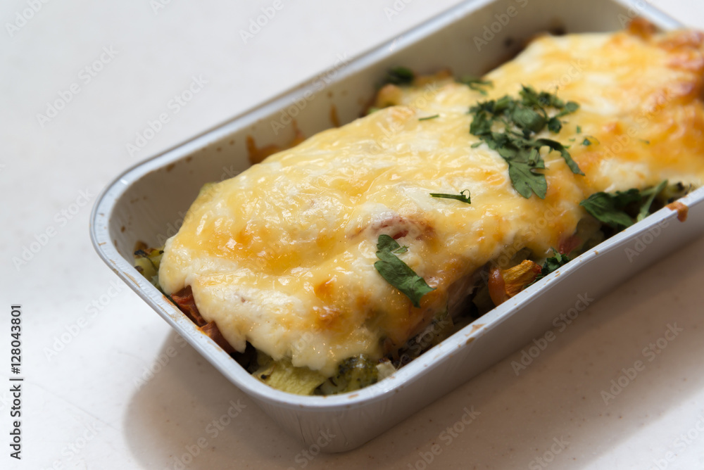 Trout baked with vegetables and cheese in batch trays
