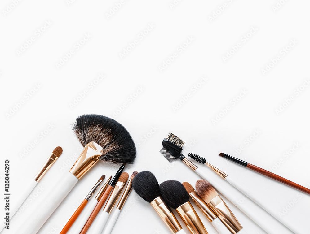 Set of flat top view of various professional female cosmetics brushes for makeup isolated on white background. Set of flat top view of various professional female cosmetics brushes for makeup isolated on white background.