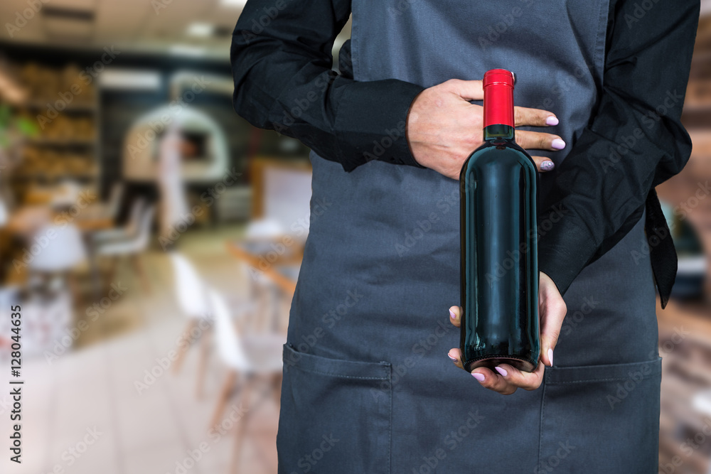 Fototapeta premium woman waitress suggesting bottle of wine