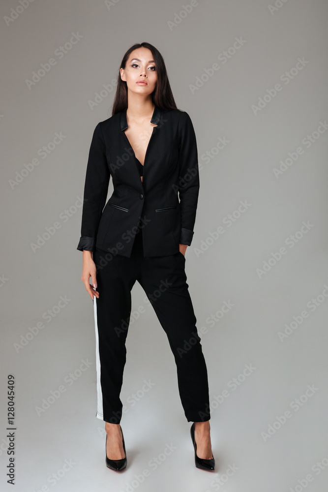 Portrait of a beautiful smart woman in black suit standing Portrait of a beautiful smart woman in black suit standing