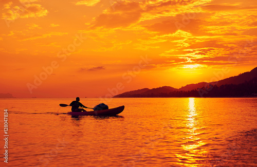 Sunset. Man on a boat in the sea