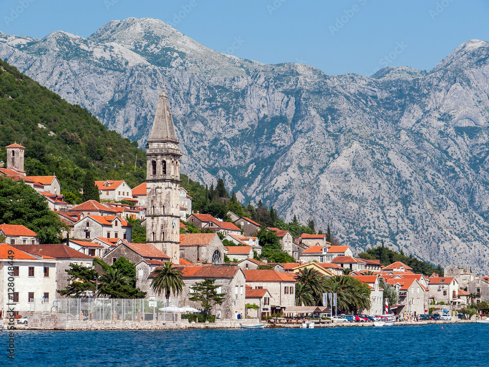 Medieval town with a bell tower on the beach line against the backdrop of the mountainsPerast Town, Bay of Kotor, Montenegro